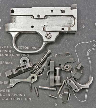 Original Ruger 10/22 trigger parts after being removed from the vintage aluminum housing