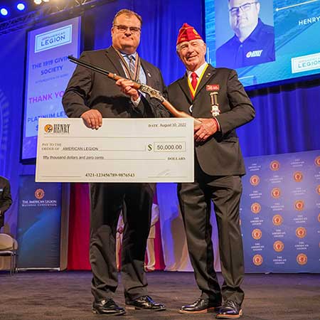 Henry Repeating Arms Company President Andy Wickstrom (L) presents a $50,000 check and a Henry Military Service Tribute Edition rifle to The American Legion National Paul E. Dillard (R) at the organization’s National Convention in Milwaukee, Wis., on August 30, 2022.