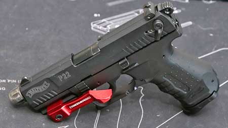 The photo you came to see. A red Accelerator Thumb Ledge installed on a Walther P22