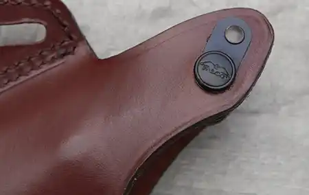 Close-up of the steel-reinforced thumb break and molded leather fit.