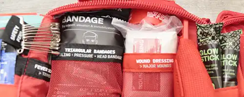 Glow sticks, triangular bandage, and wound dressing in the SurviveX Large First Aid Kit