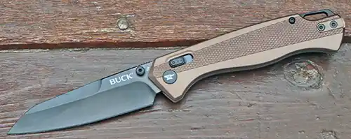 Buck 698 Ferrox open on wood showing reverse tanto blade