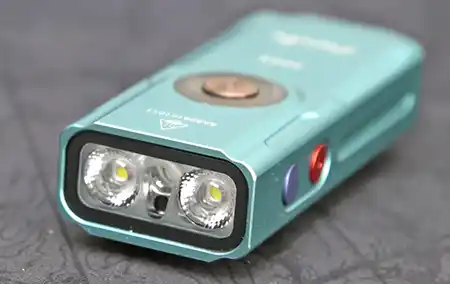 Close-up of the Fenix E06R front emitters with purple UV button and red laser button