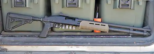 Mossberg 590 with Mesa Tactical LEO Gen II Telescoping Stock Adapter stored in a vehicle cargo area