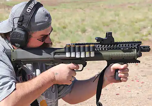 Shooter testing a Kel-Tec KSG with the Mesa Tactical SureShell Carrier and Rail