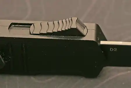 Tekto A2 Badger automatic knife with contoured deployment button