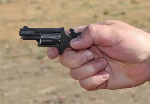 NAA Mini-Revolver held in one hand to show its small size